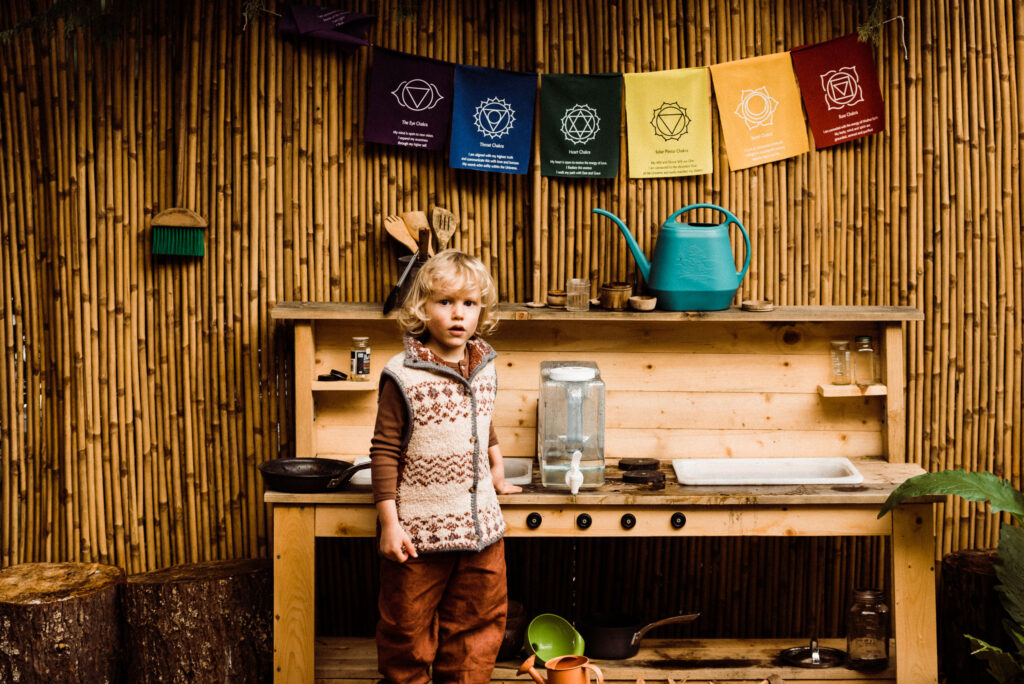 Nature schooling often involves unstructured play like mud kitchen play in the backyard.